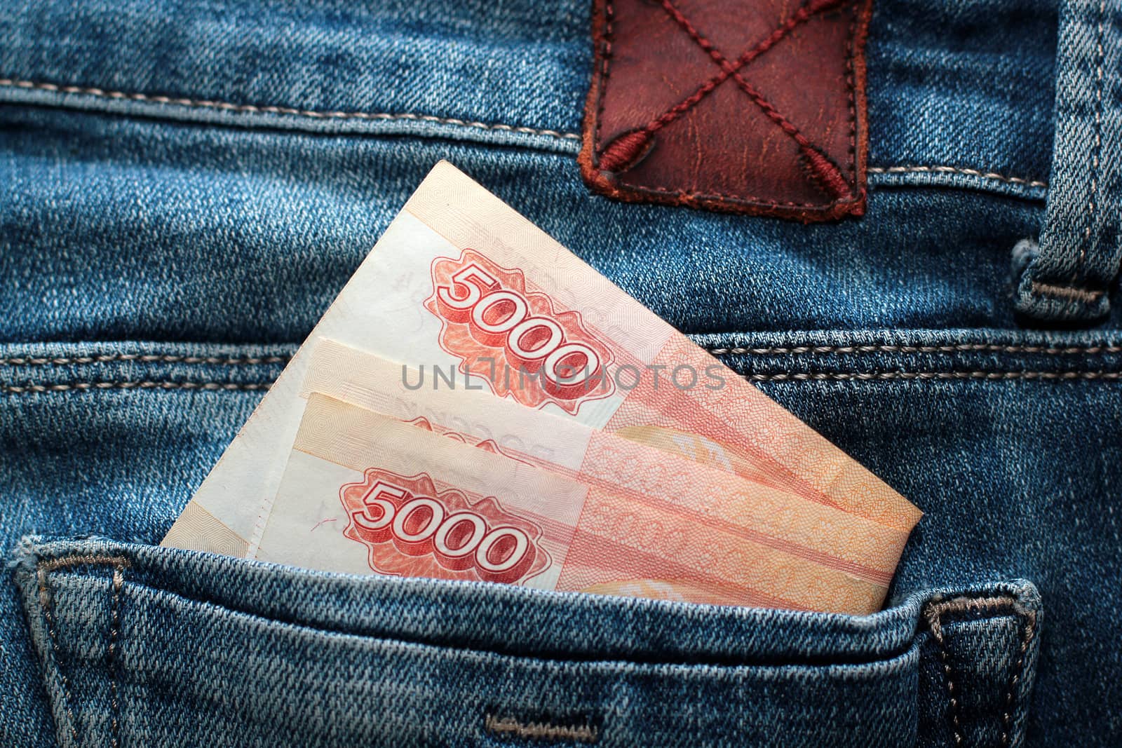 Russian money roubles in blue jeans pocket as a top view image