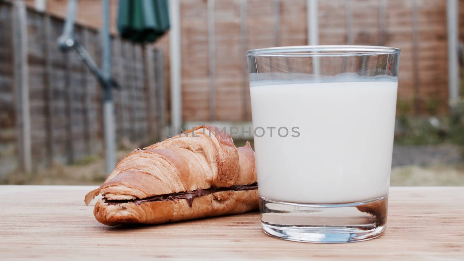 Delicious fresh and tasty chocolate croissant and white cold milk.