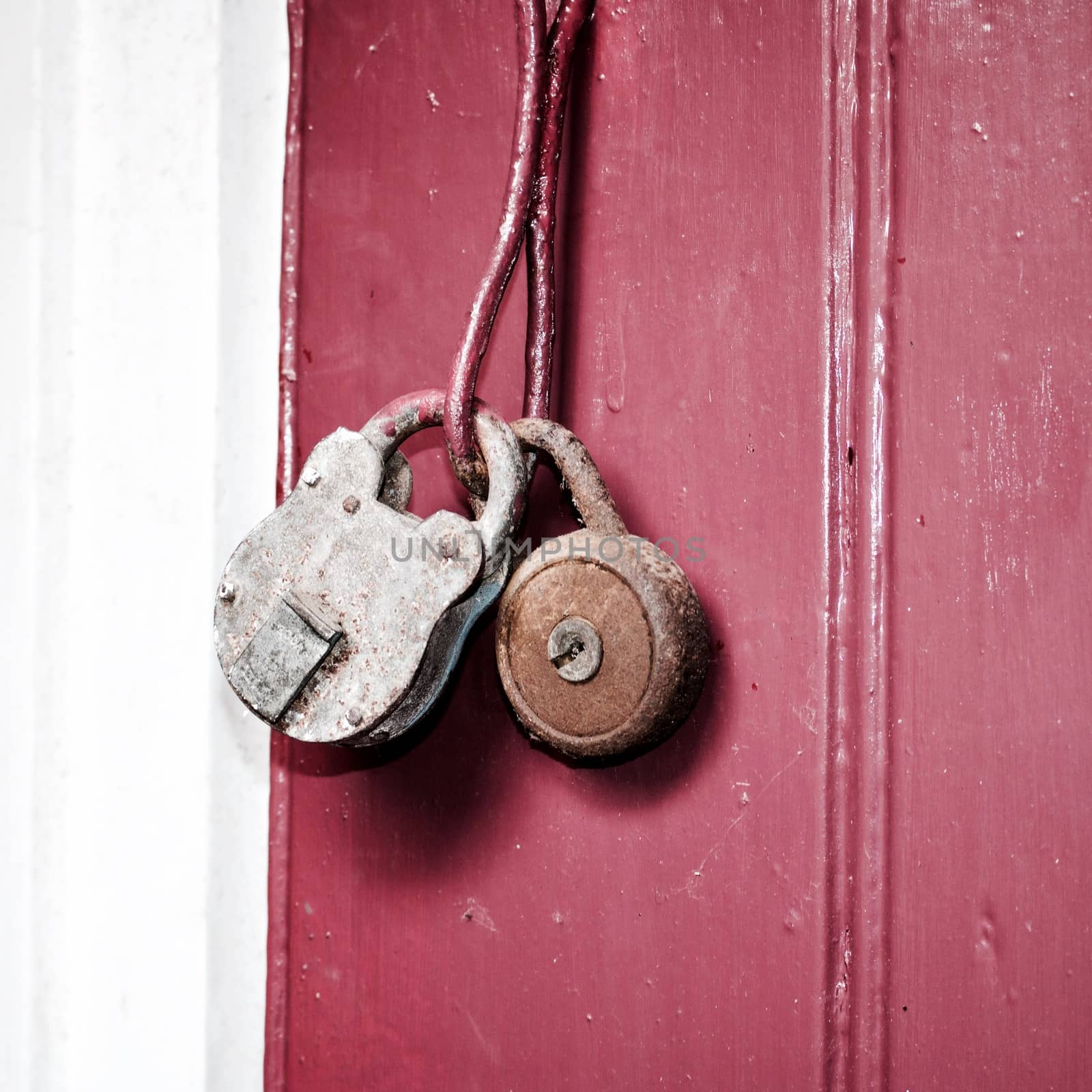 Two old and dirty lockers on the red doors. Village fashion in the garden.