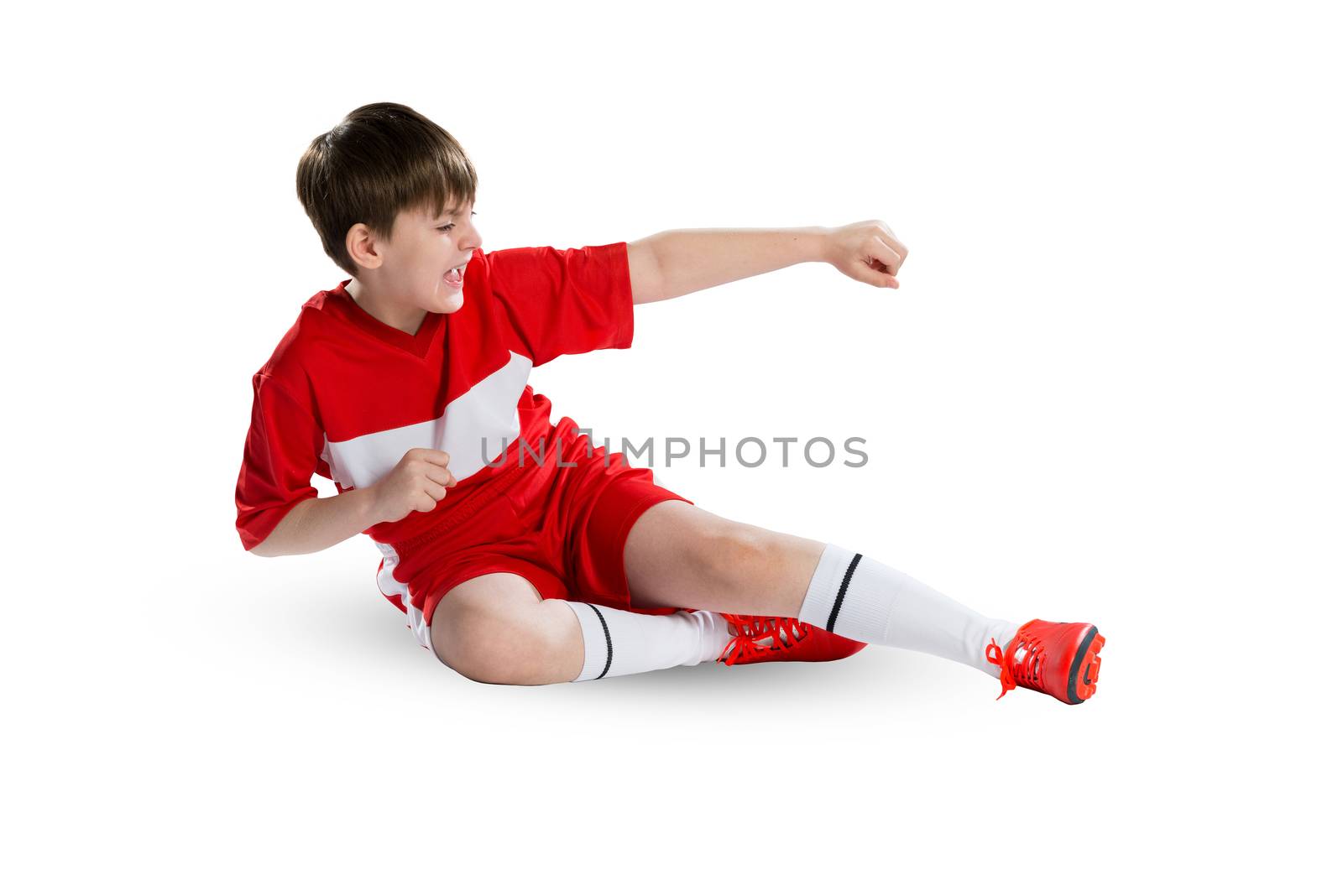 Boy football player in red uniform against white background