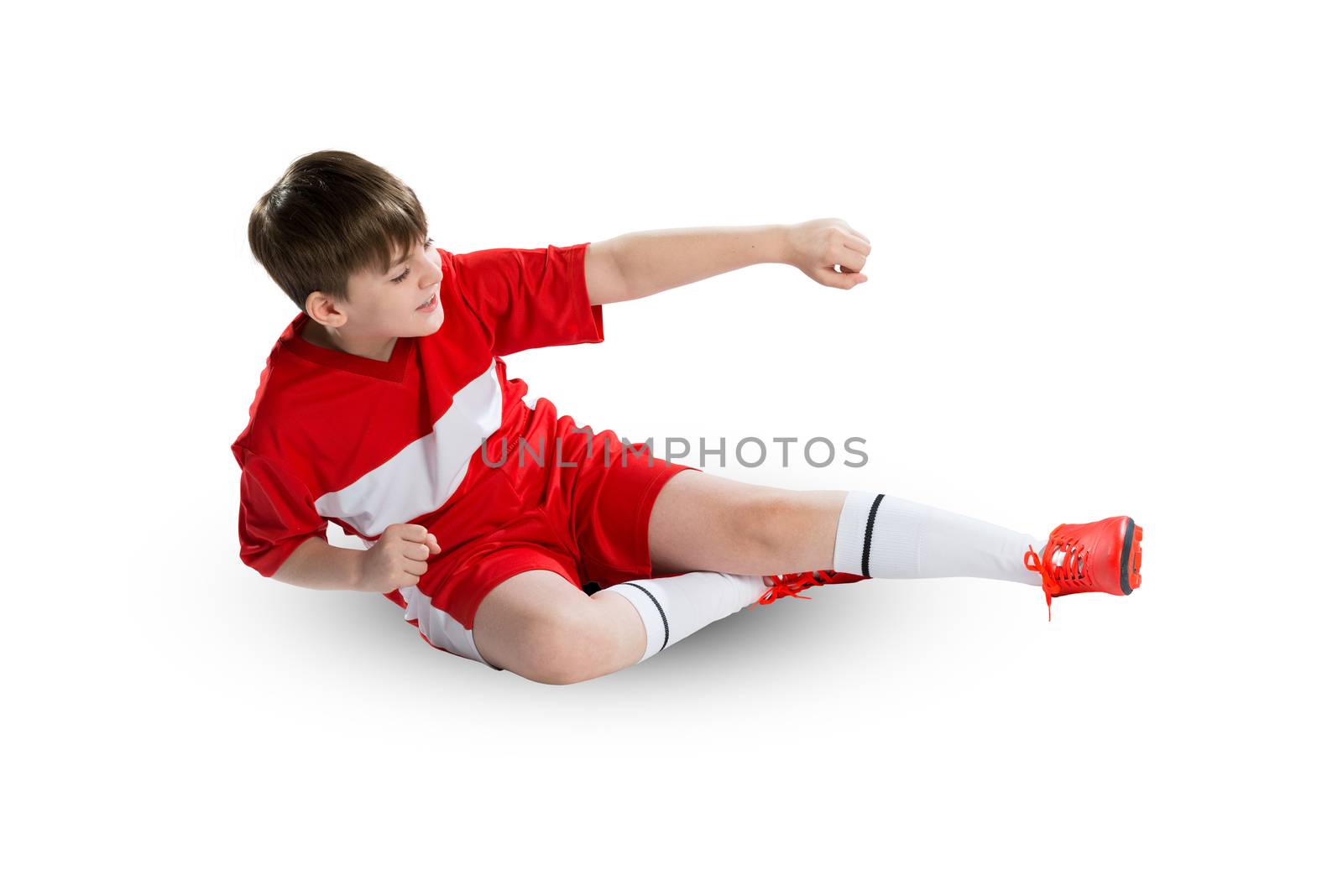 Boy football player in red uniform against white background