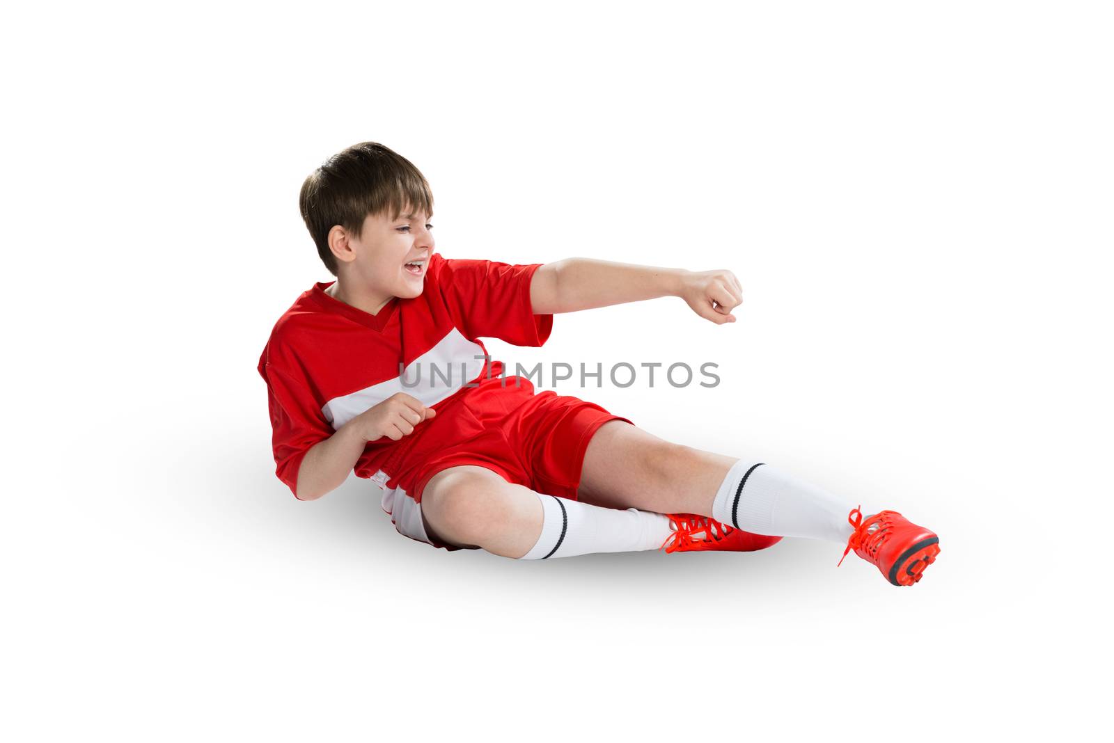 Boy football player in red uniform against white background