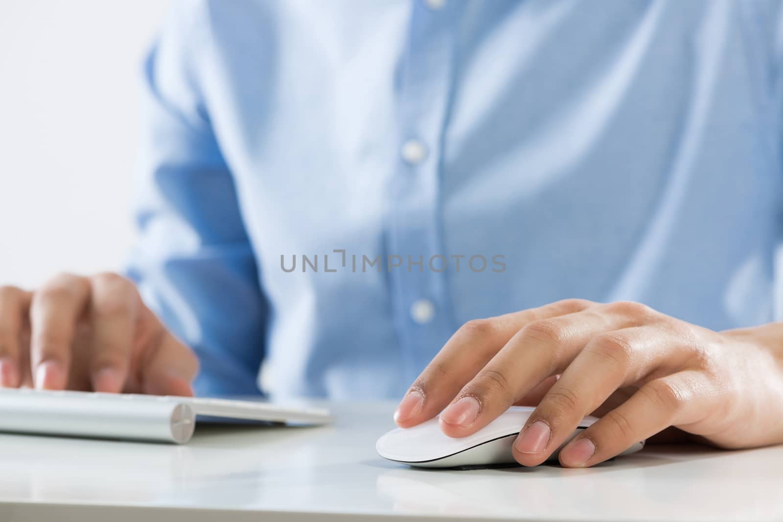 Young man sitting at desk and working on computer