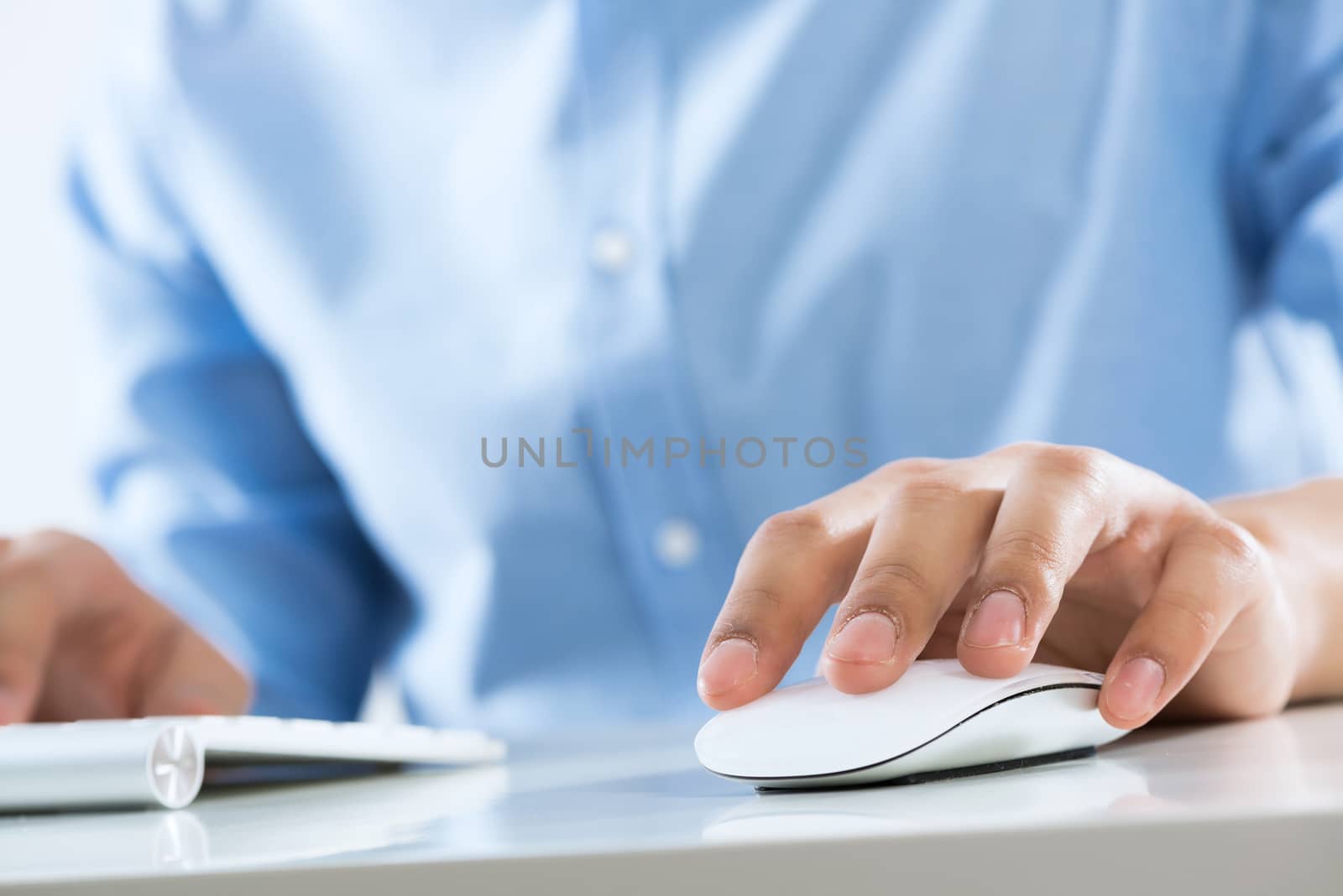 Young man sitting at desk and working on computer