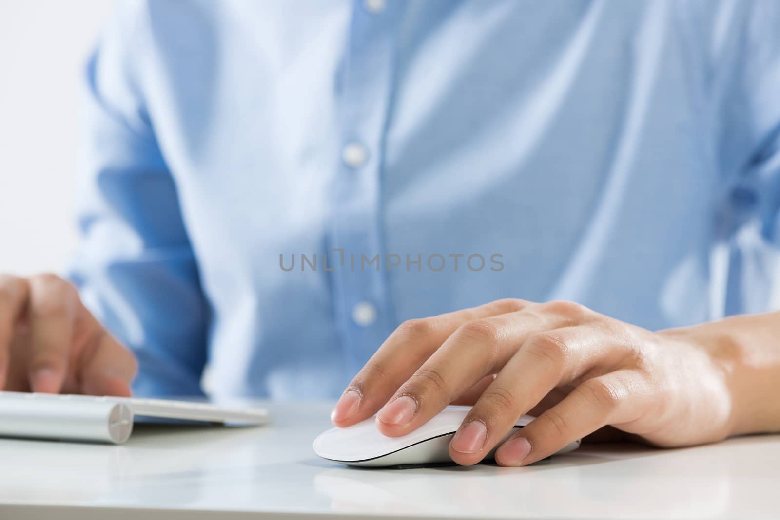 Young man sitting at desk and working on computer