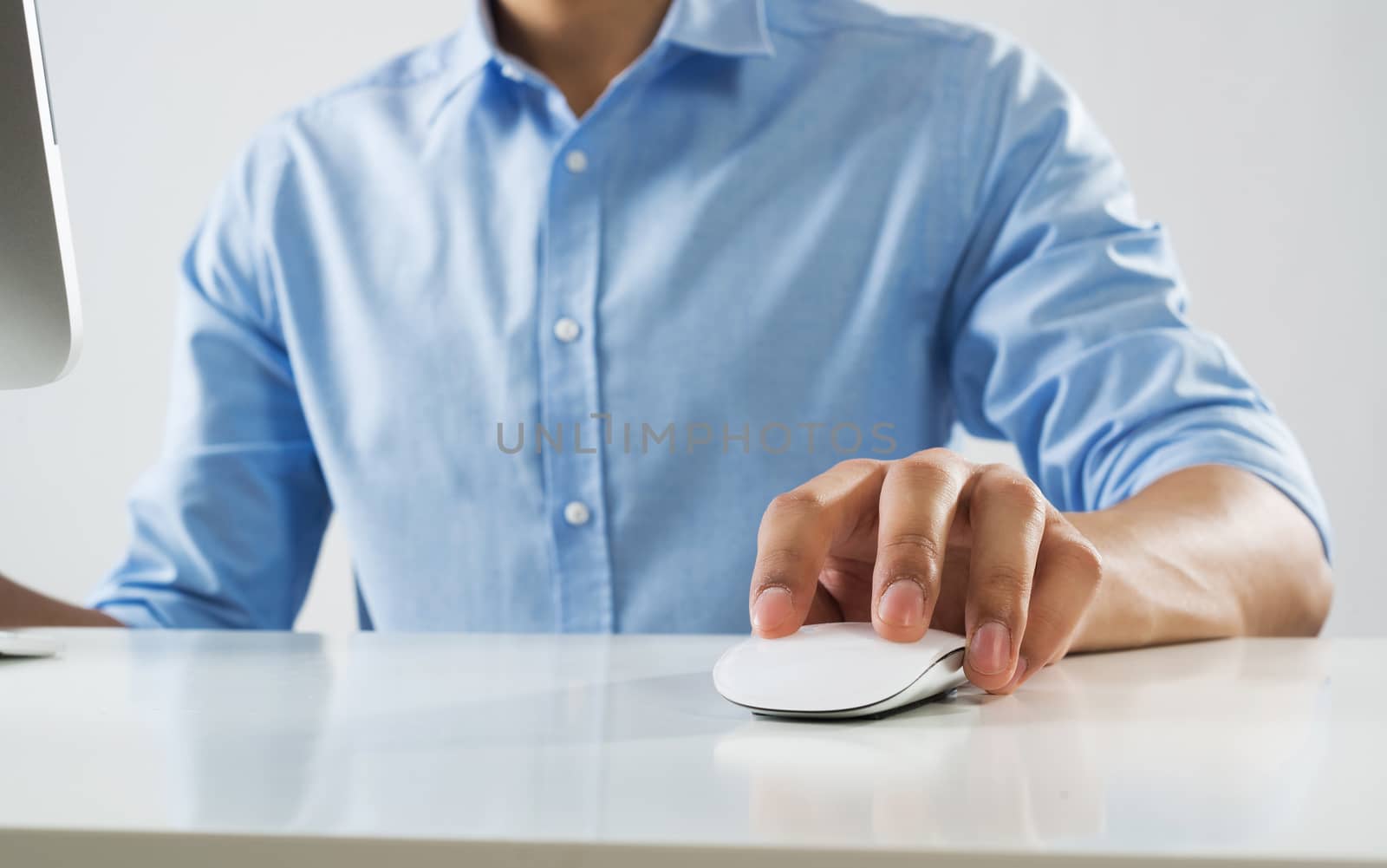 Young man sitting at desk and working on computer