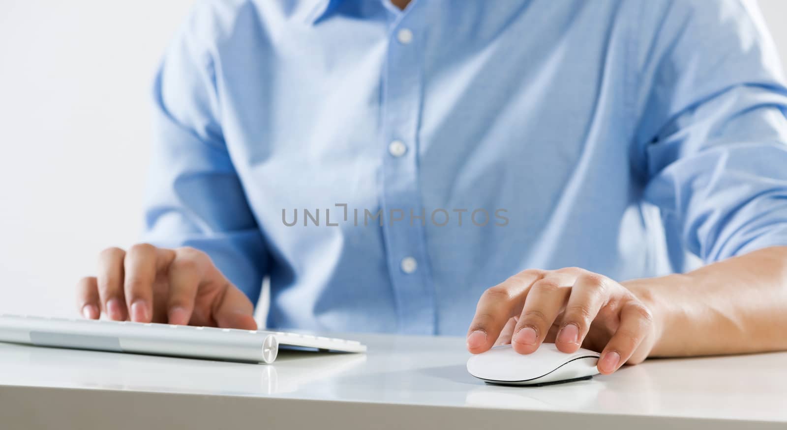 Young man sitting at desk and working on computer