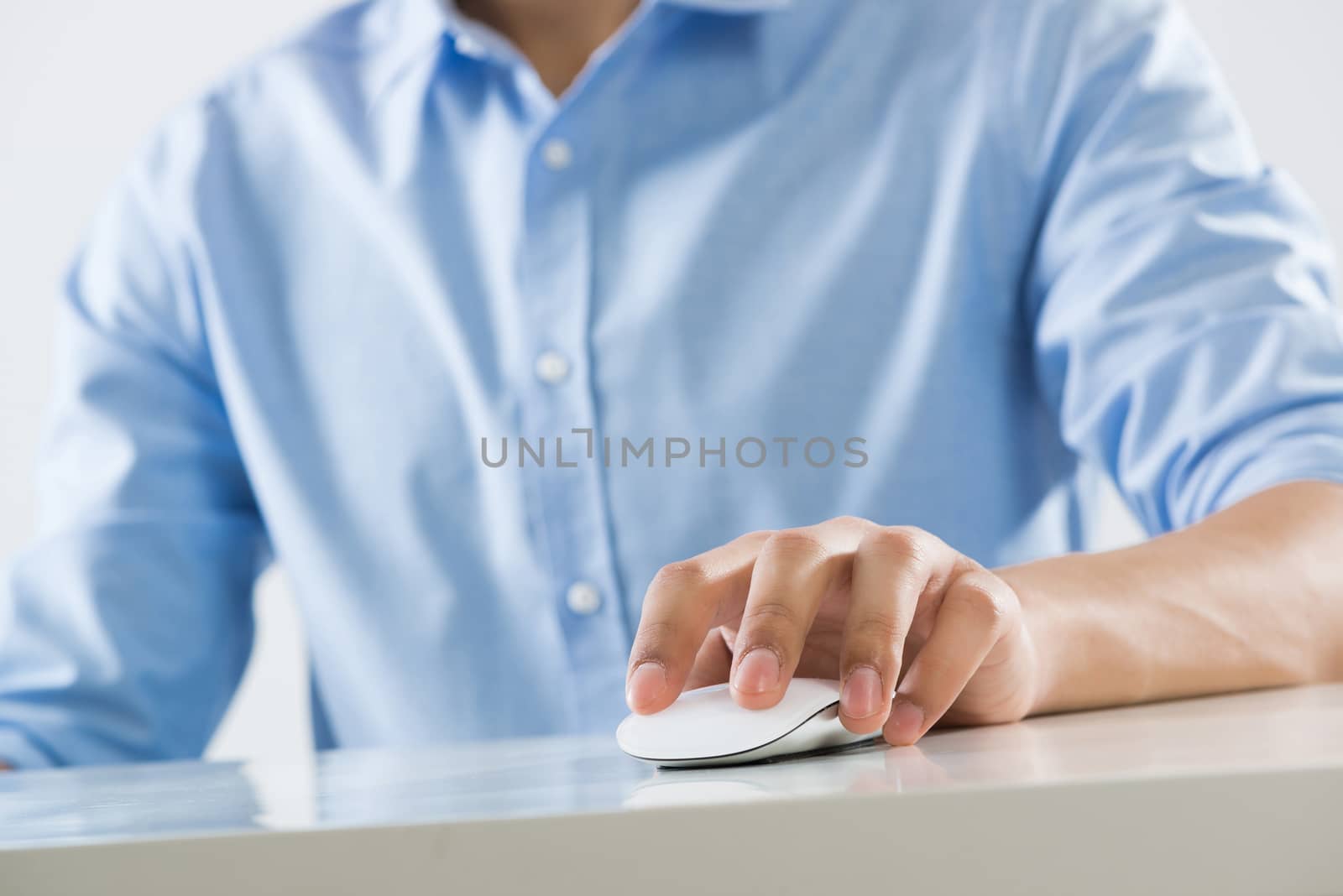 Young man sitting at desk and working on computer