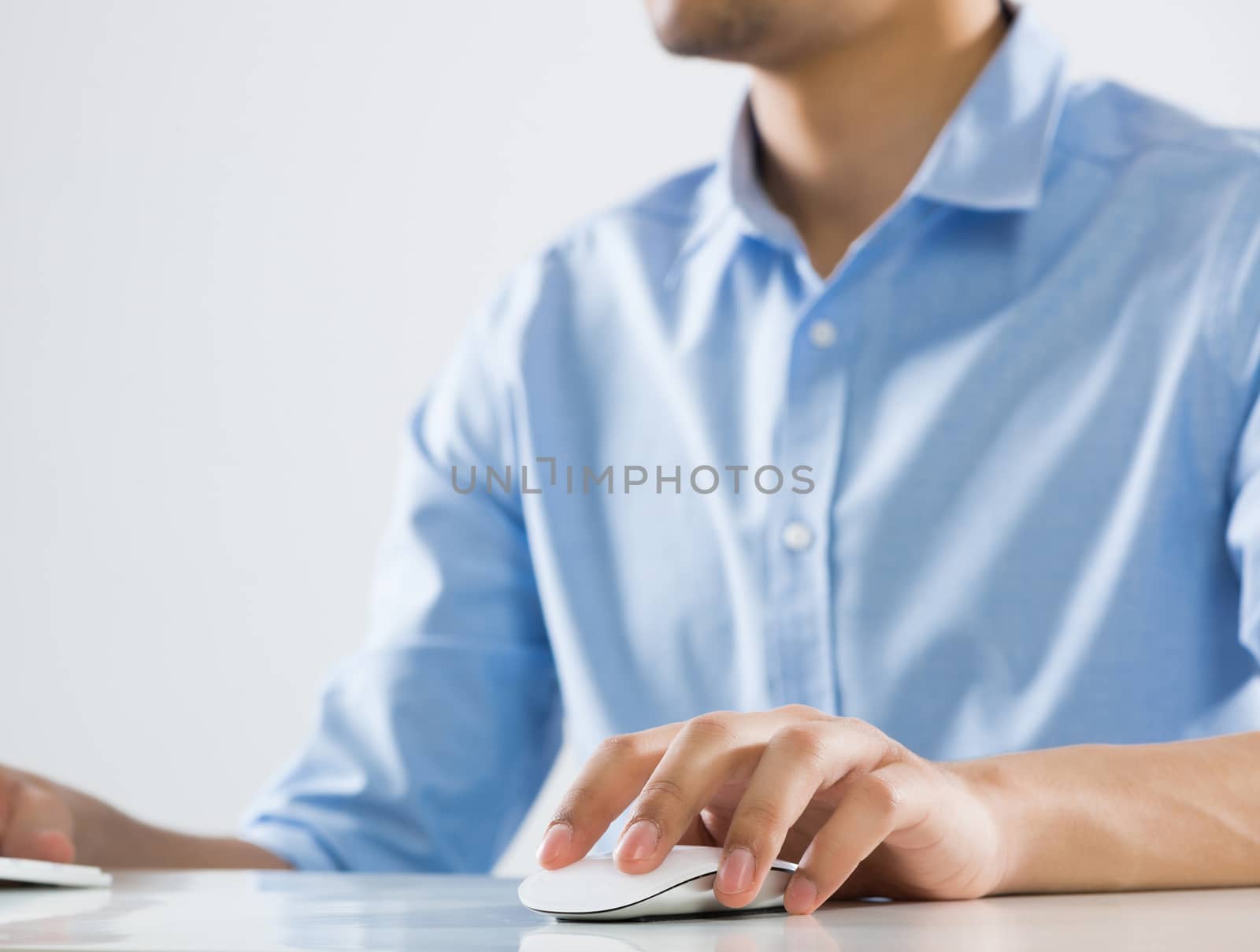 Young man sitting at desk and working on computer