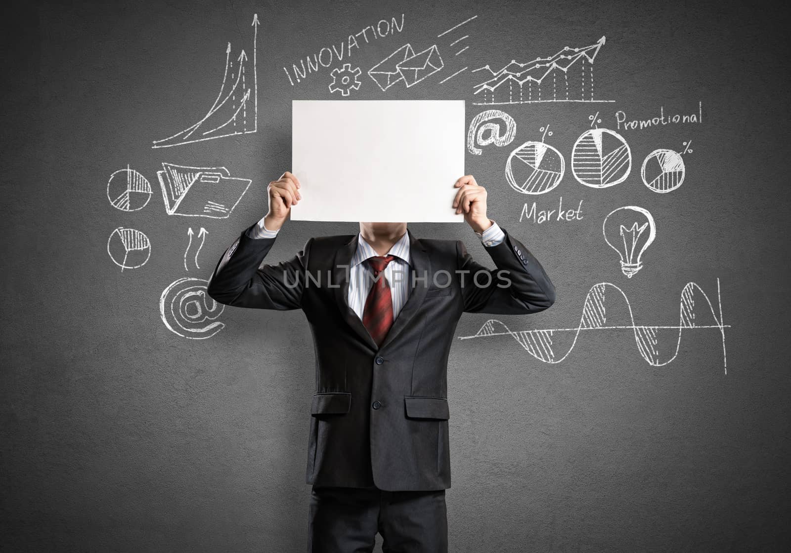 Businessman hiding his face behind sheet of paper
