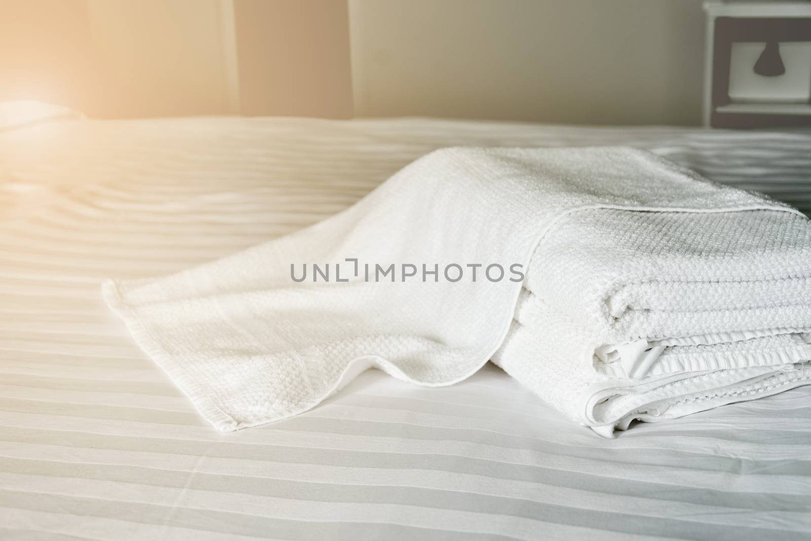 white towel on white mattress fabric, with soft light vintage. by rakoptonLPN