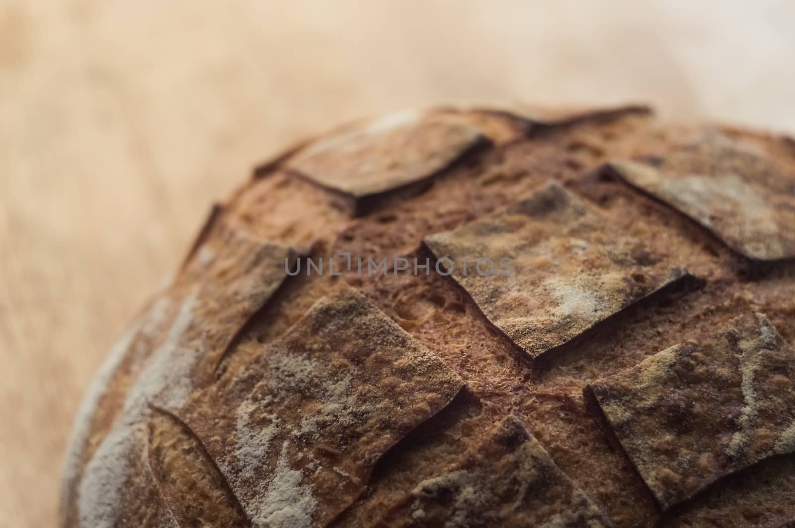 Close-up of artisan bread on wooden background by Milovan