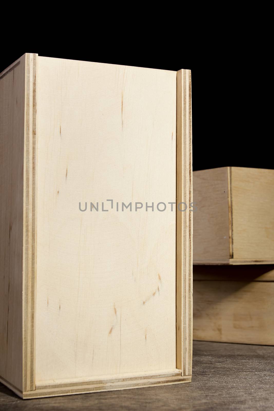 Light wooden boxes on a dark background