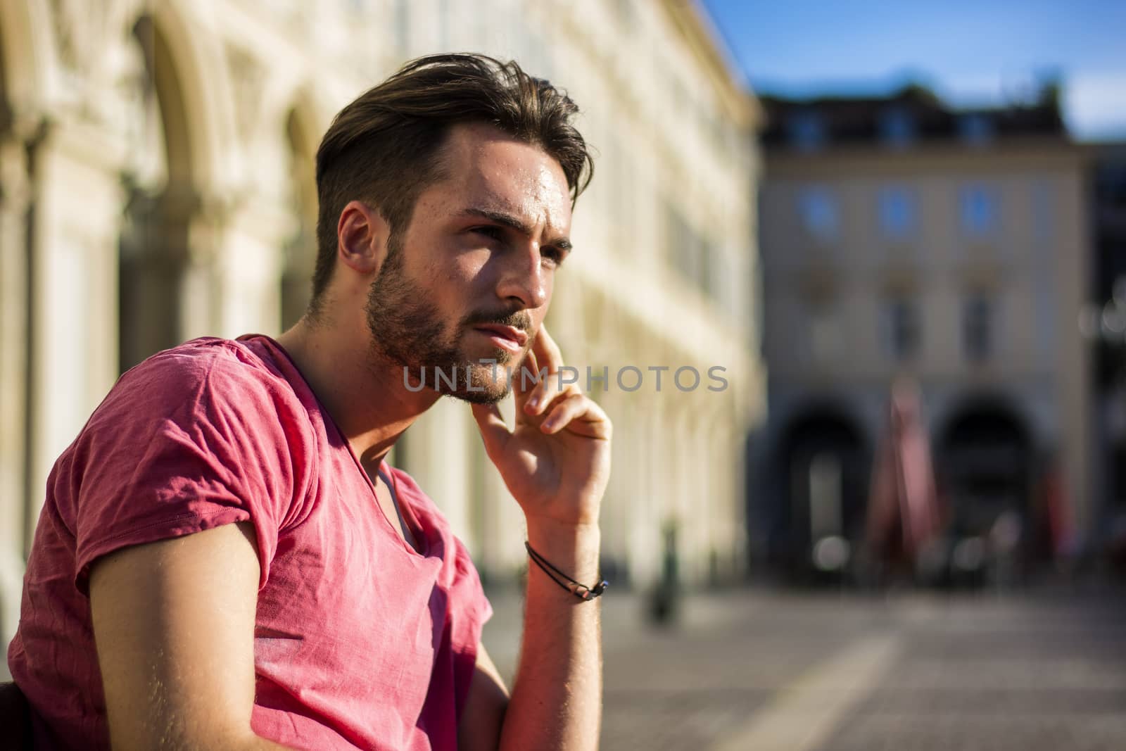 One handsome young man in urban setting in European city