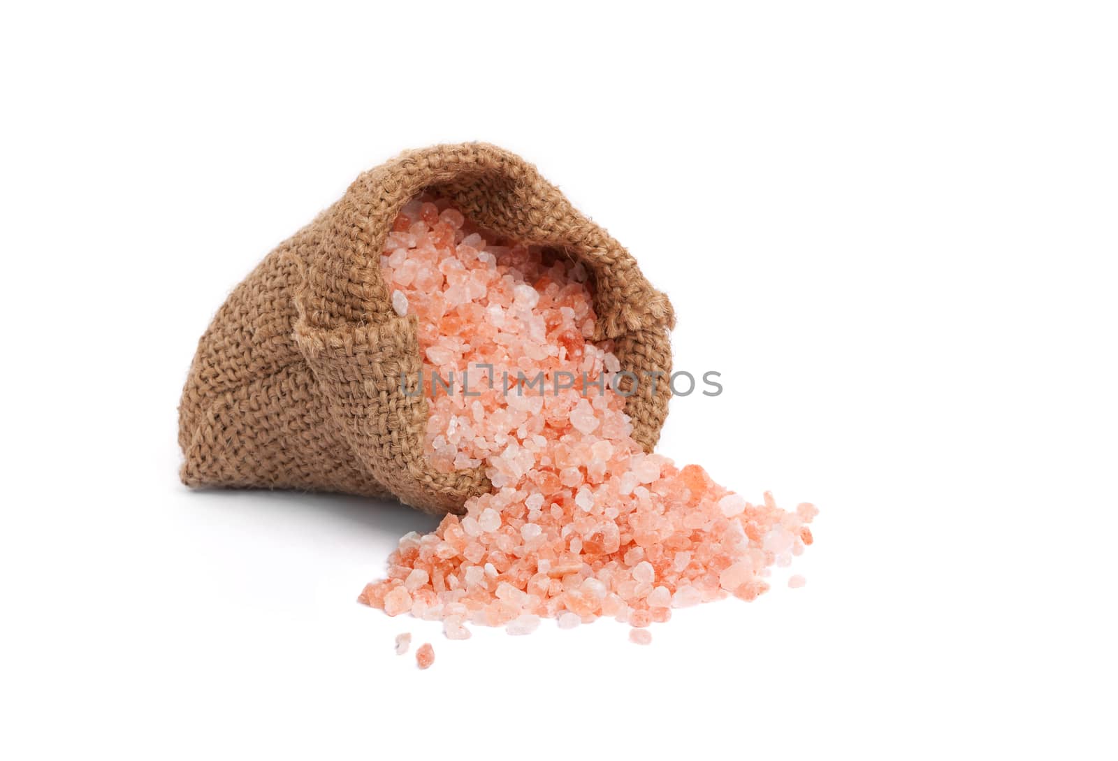 Himalaya pink salt in burlap bag isolated on white