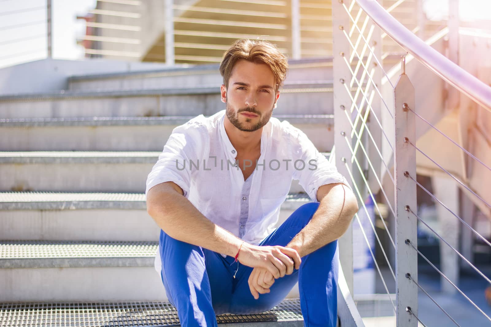 One handsome young man in urban setting in European city