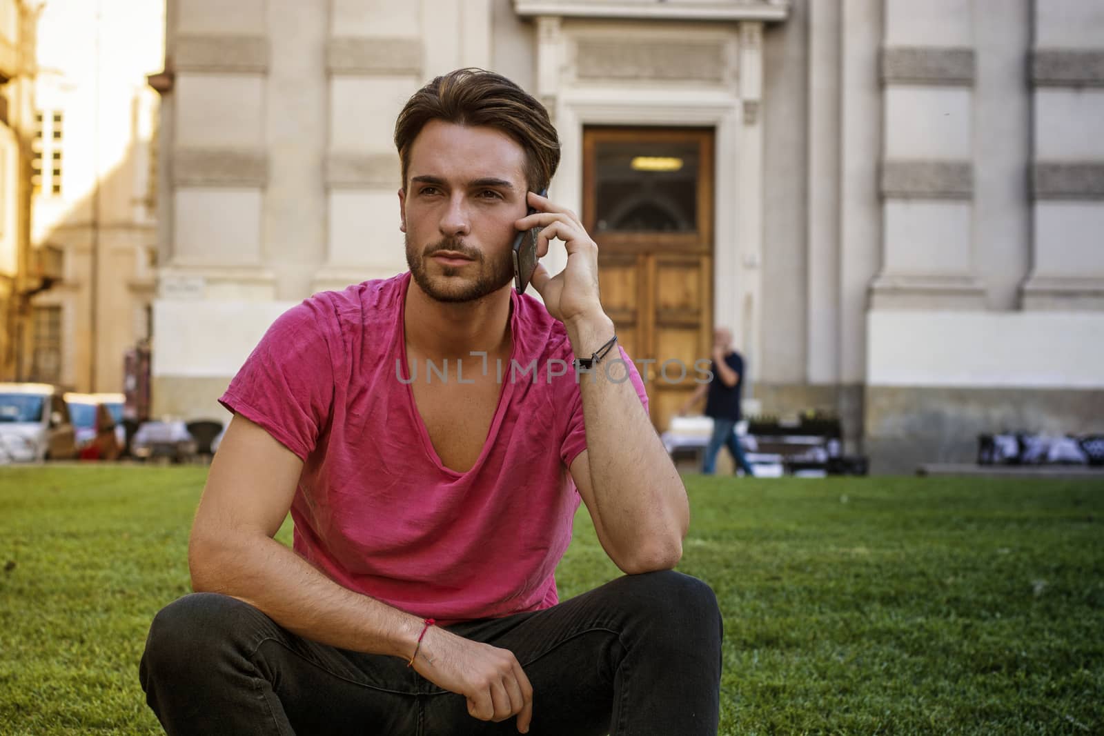 One handsome young man in urban setting in European city