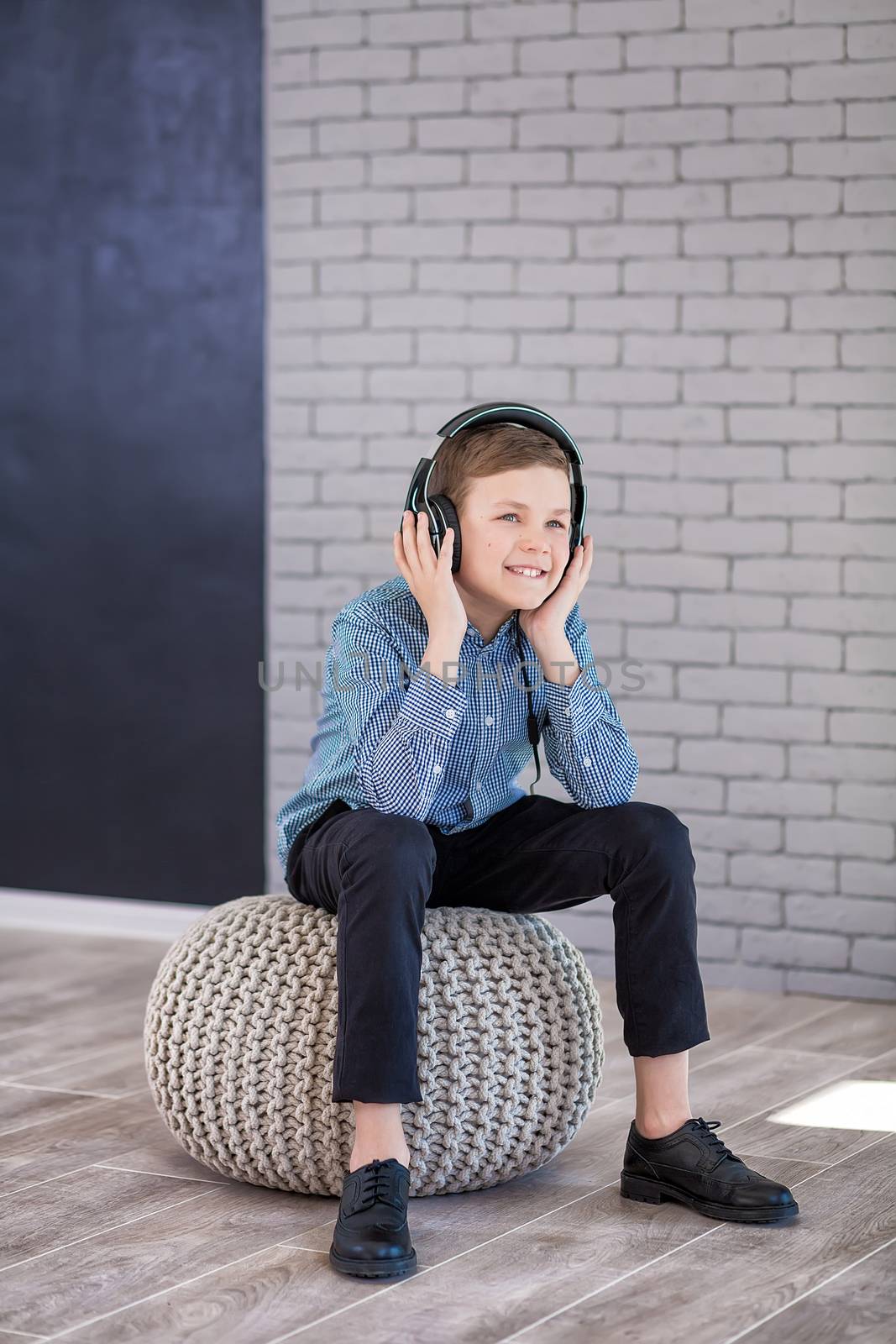 Relax and listening music concept. European boy fill the bit. Portrait of head in headphones with closed eyes. Boy in casual wear.
