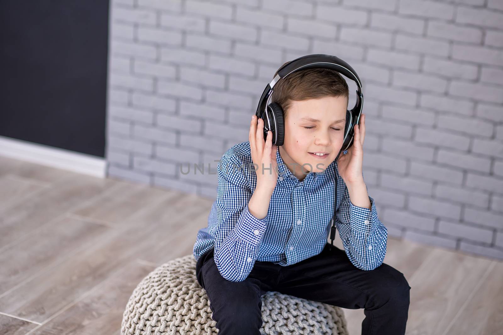 Relax and listening music concept. European boy fill the bit. Boy in casual wear. by dlukashenko@mail.ru