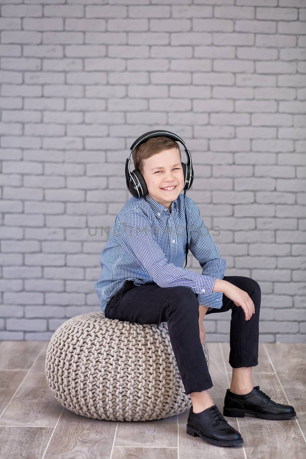 Relax and listening music concept. European boy fill the bit. Portrait of head in headphones with closed eyes. Boy in casual wear.