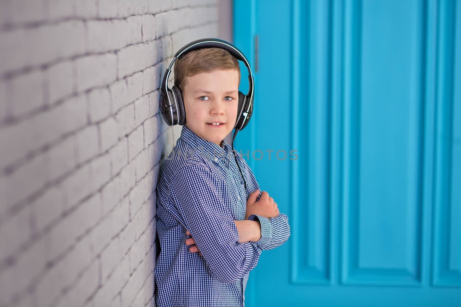 Relax and listening music concept. European boy fill the bit. Portrait of head in headphones with closed eyes. Boy in casual wear.