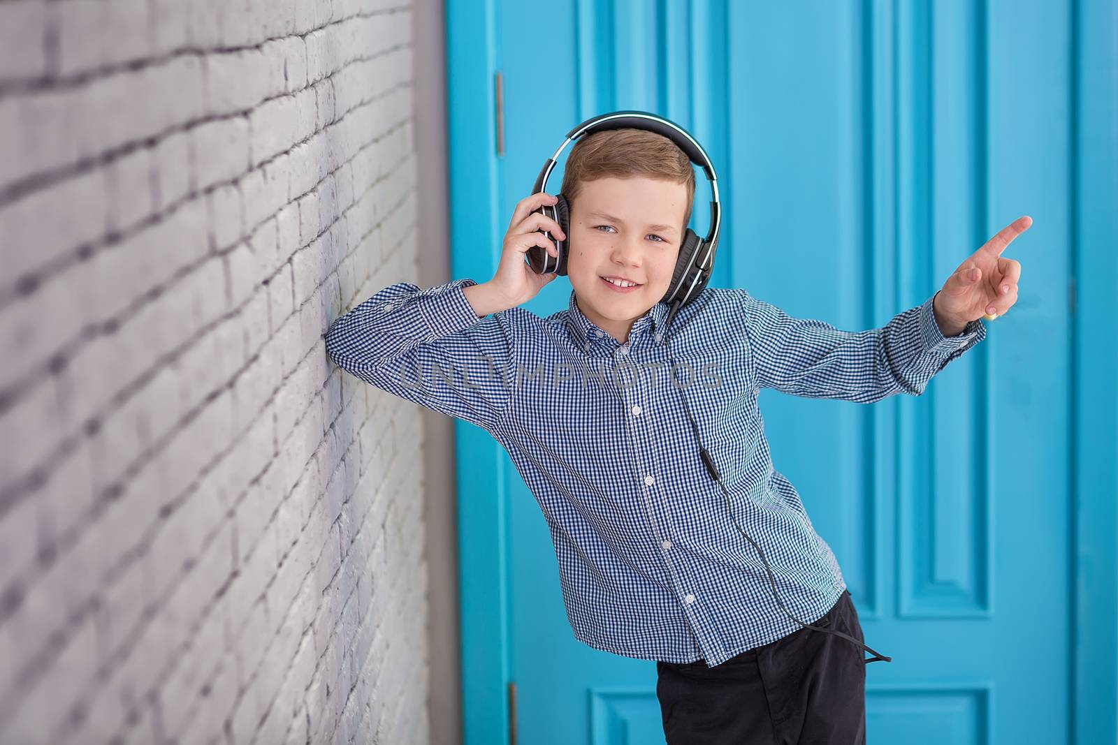 Relax and listening music concept. European boy fill the bit. Portrait of head in headphones with closed eyes. Boy in casual wear.