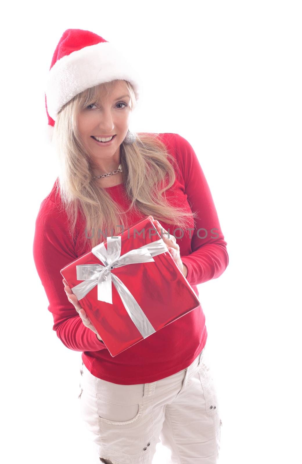 A woman holding a red wrapped Christmas present tied up with silver ribbon.