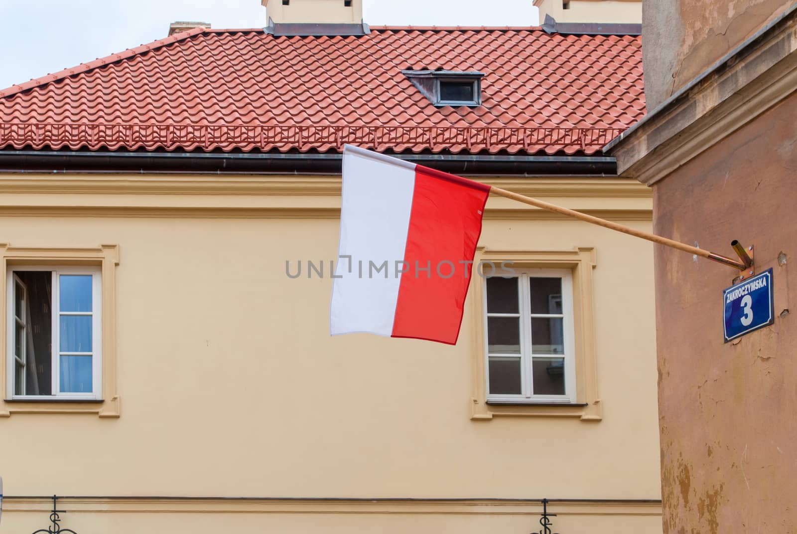 Waving flags of Poland in the wall of a building in Warsaw