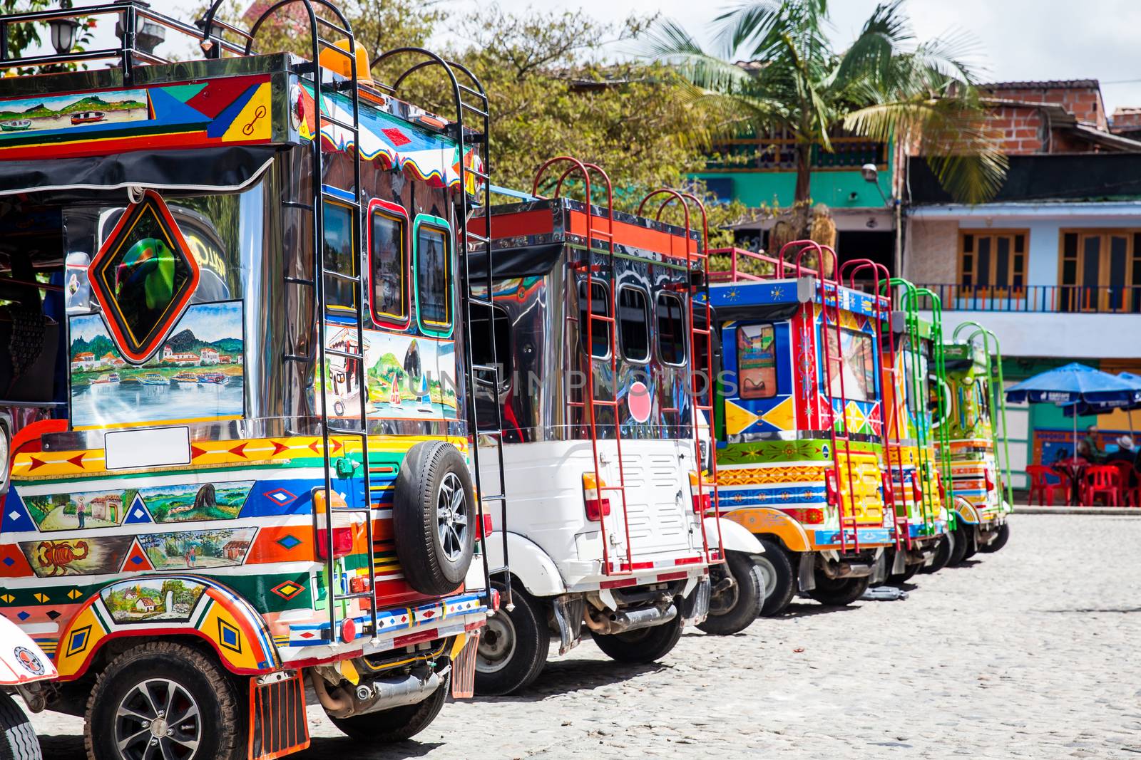Motor-tricycles decorated as traditional Colombian chivas at the colorful Guatape city.