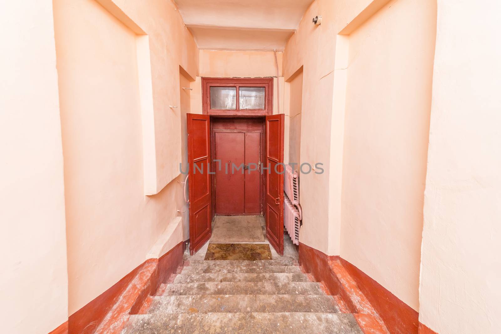 empty entrance in apartment building stairwell beige color