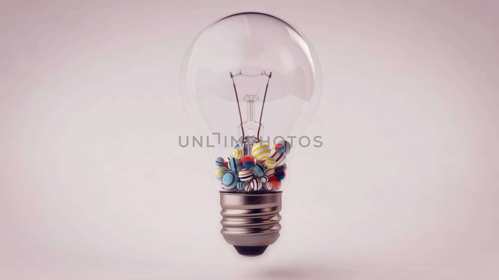 An impressive 3d illustration of a transparent glass ligh bulb with a metallic wire and small striped and multicolored balls in it. They are in the down part of a lamp put in the grey background. 