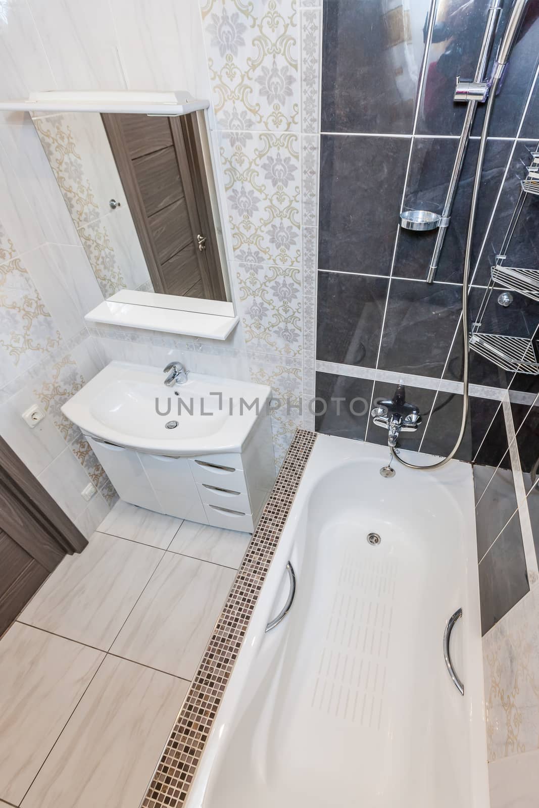 Small beige tile bathroom with bath tube and sink