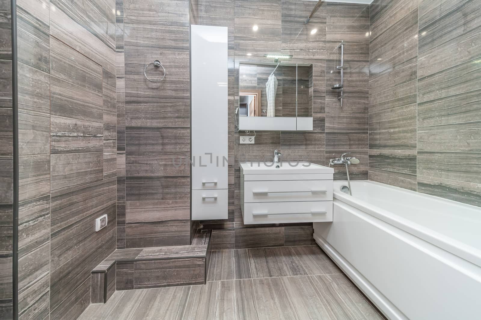 Small beige tile bathroom with bath tube and sink