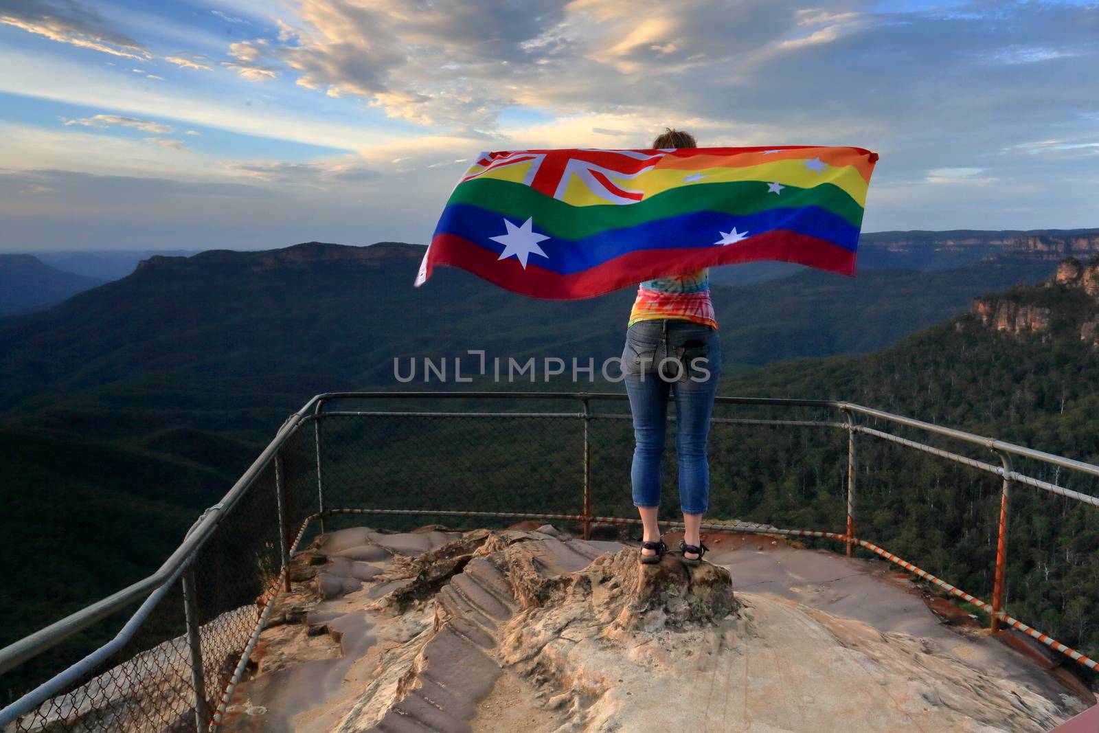 Woman holding an Australian flag in rainbow colour.  On November 15 2017 Australian voted yes to Equality Marriage rights.