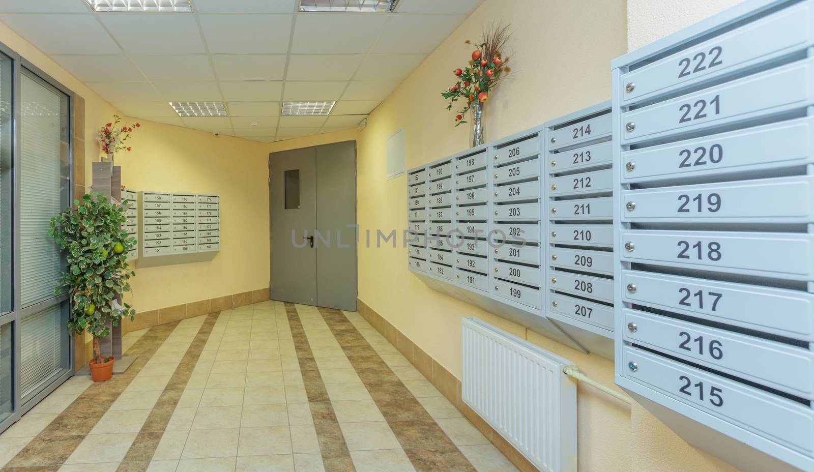 Empty hall mailboxes and doors at new apartment building