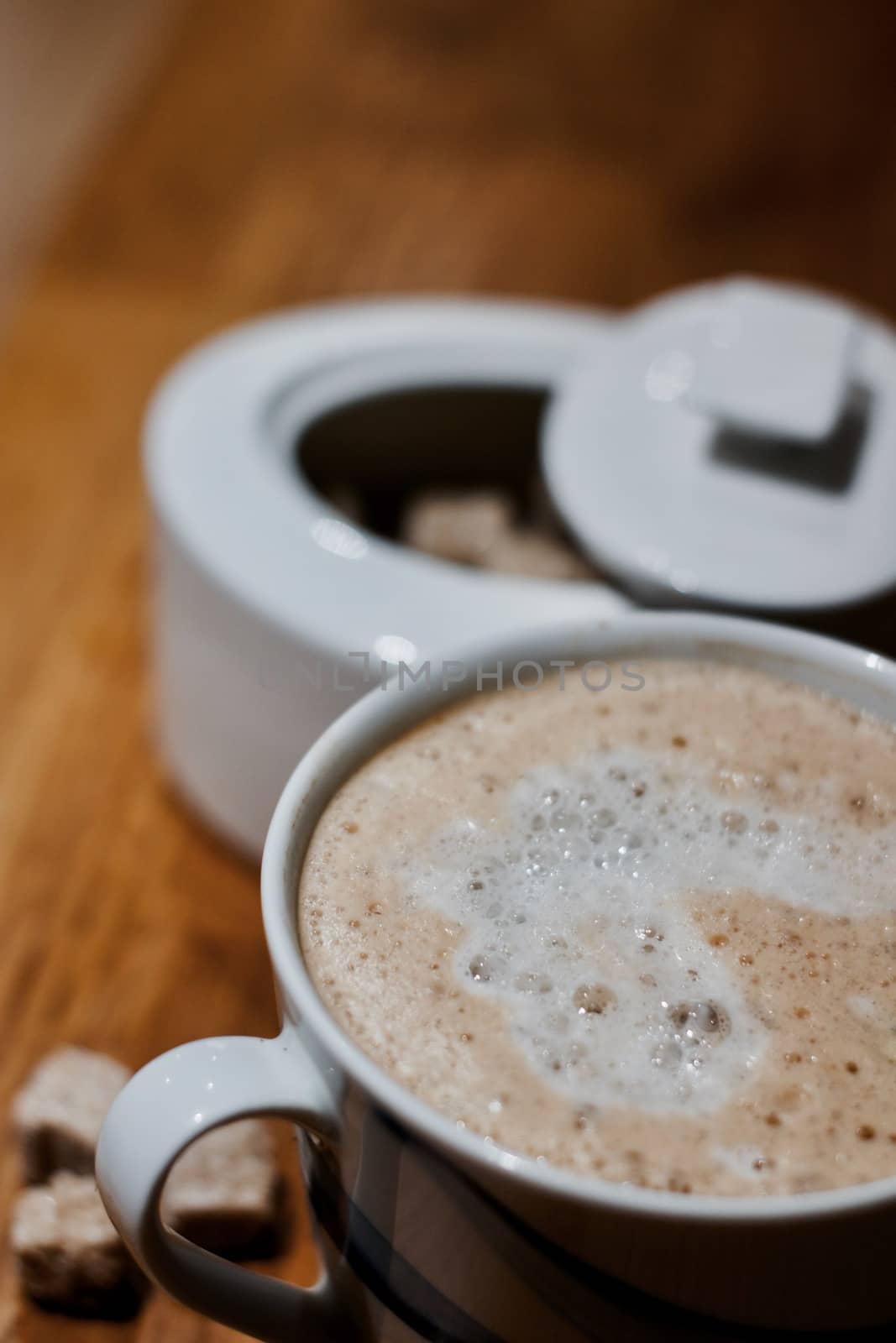 Fresh and tasty coffee in the kitchen on the wooden board. Drink concept.