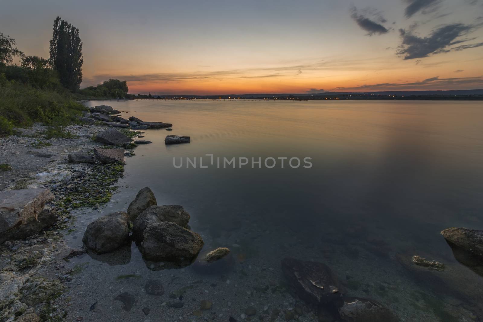 Sea sunset seascape with wet rocks. Smooth long exposure of waves by EdVal