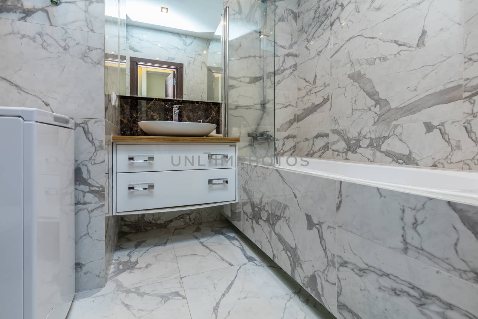 Small beige tile bathroom with bath tube and sink