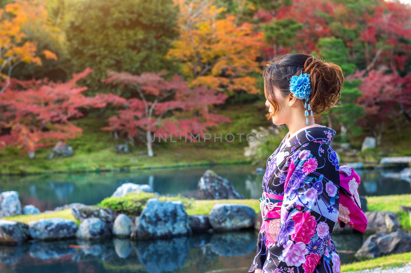 Asian woman wearing japanese traditional kimono in autumn park. Japan by gutarphotoghaphy