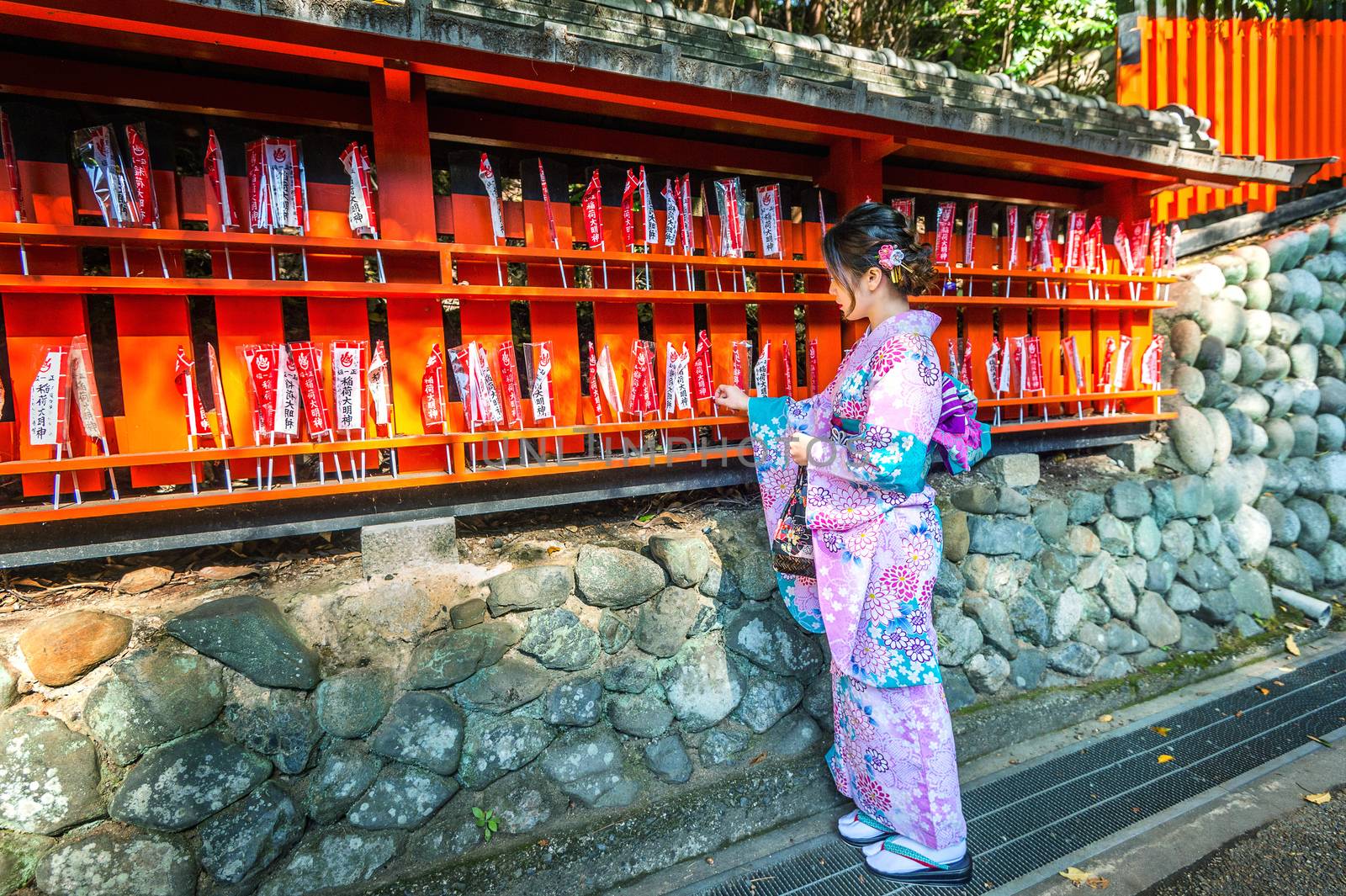 Asian women wearing japanese traditional kimono visiting the beautiful in Fushimi Inari Shrine in Kyoto, Japan by gutarphotoghaphy