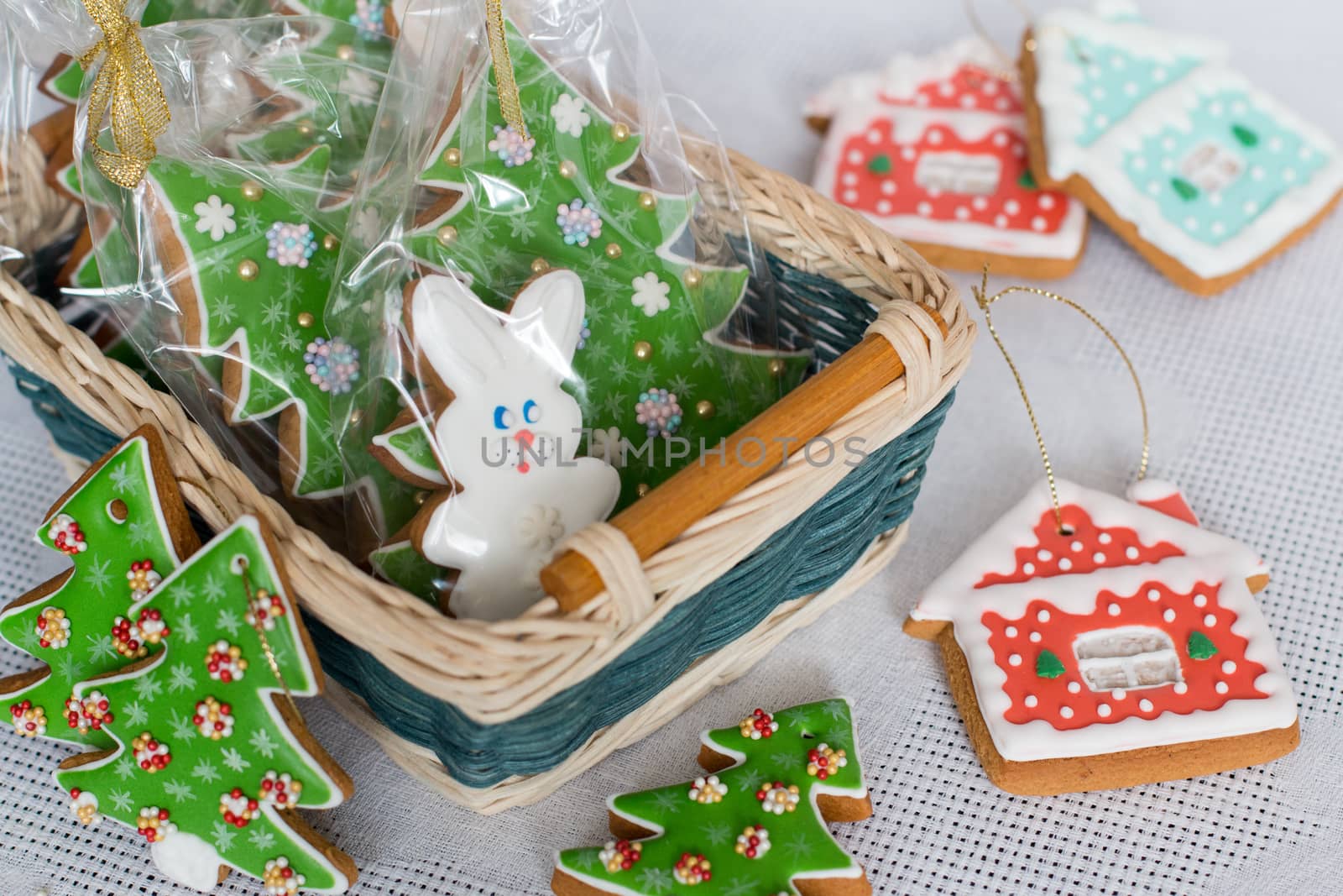 New Year's gingerbread decorated with icing in a basket. Christmas homemade gingerbread cookie in a wicker basket. Christmas and new year card with free text space
