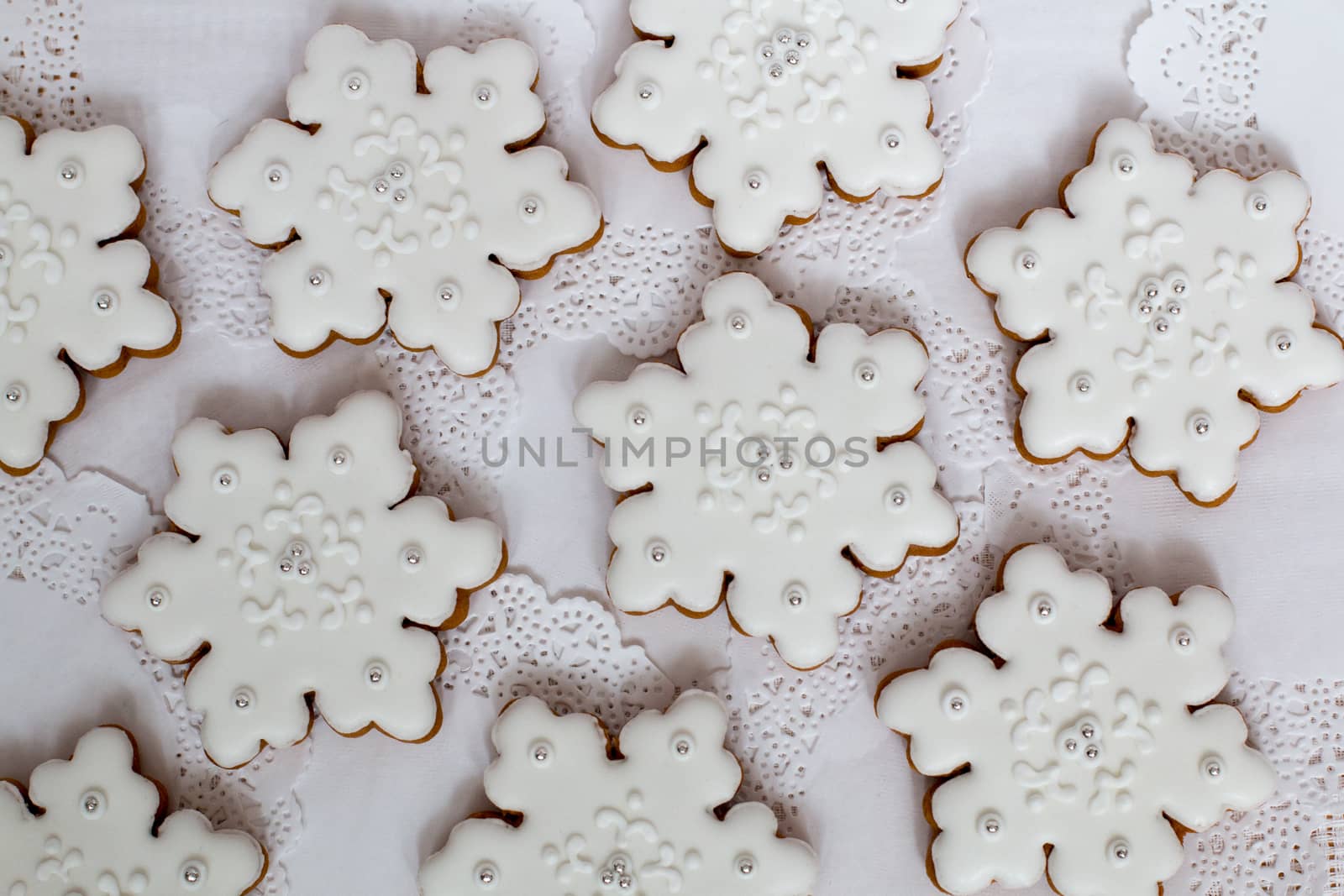 Christmas background. Gingerbread snowflake star cookies set decorated with icing on white table, flat lay. Christmas and New year traditions, winter holidays, homemade sweets, festive food
