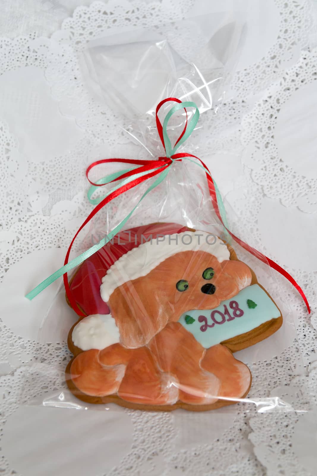 Christmas sweets in a festive package, colorful gingerbread, cookie in the form of a dog with New Year's mood. Year of the dog. Dog symbol of the year 2018. Close-up. Colorful christmas Gingerbread