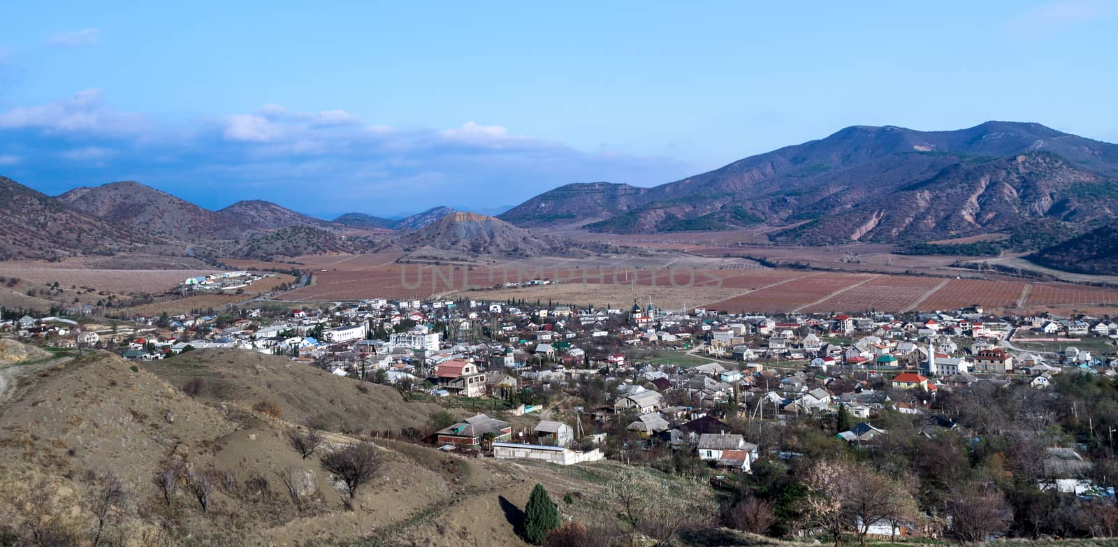 Crimean village nestled in the foothills, among autumnal vineyard