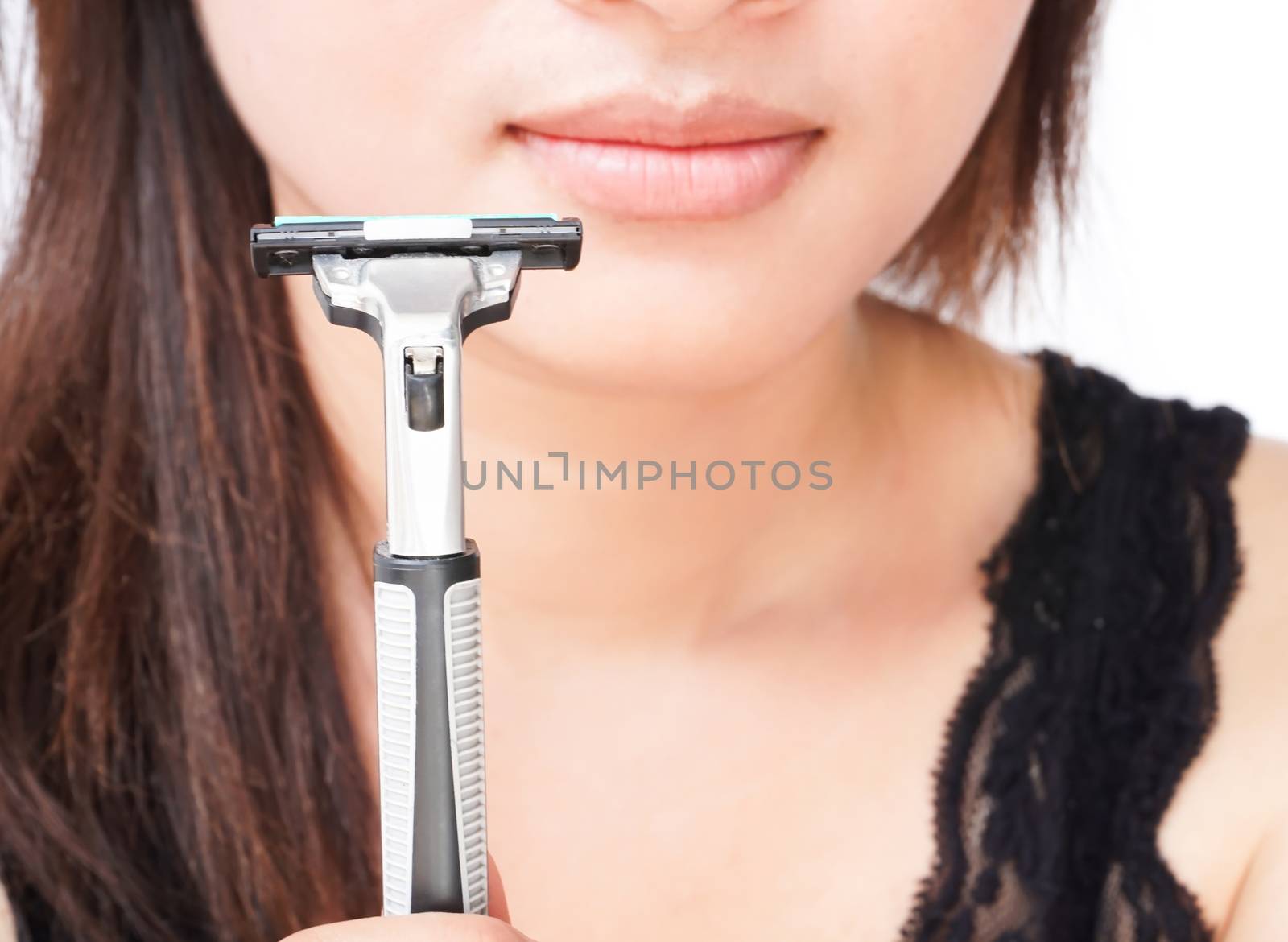 Closeup woman hand holding razor pre for shaving face, health care and beauty concept, selective focus