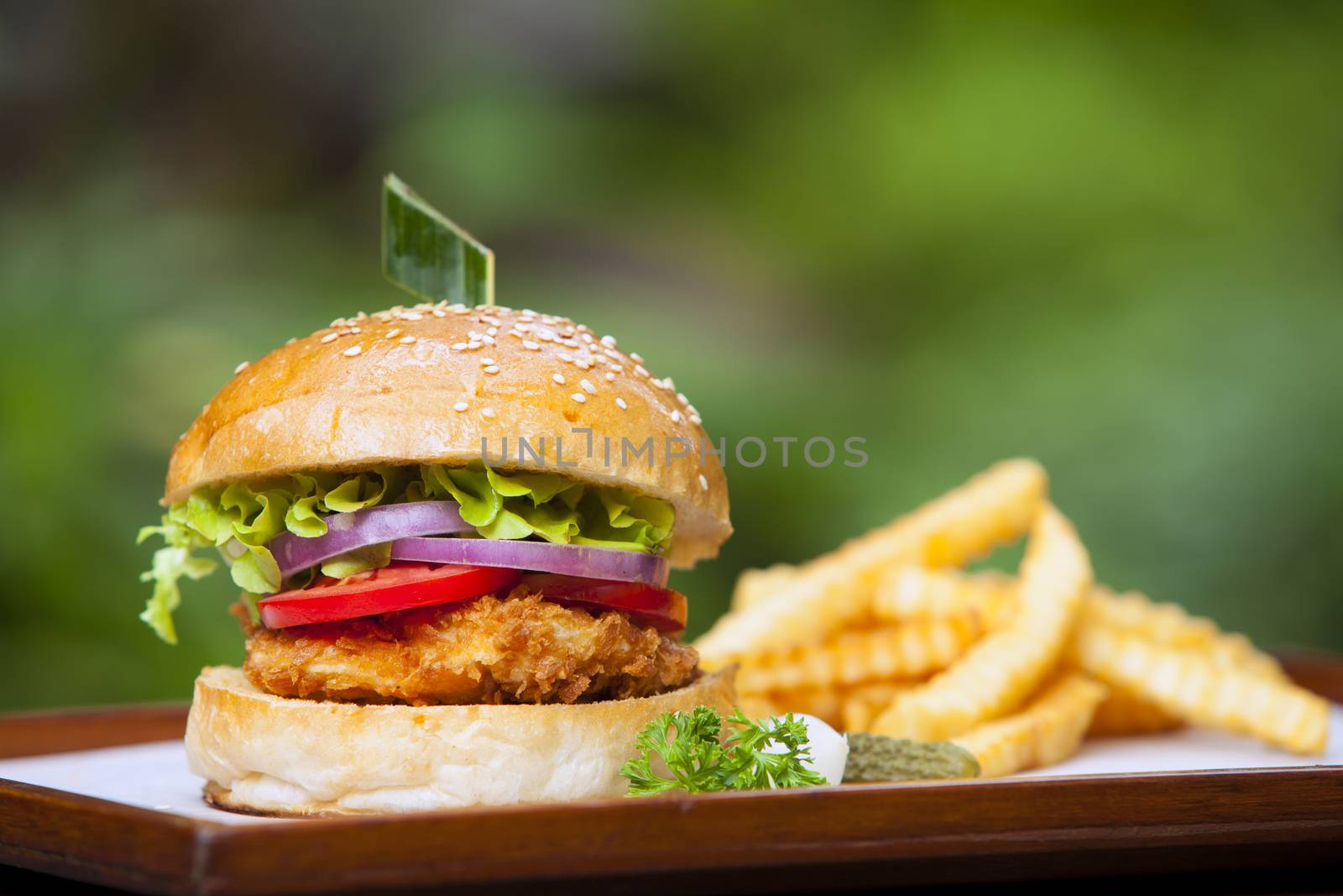 chicken burger with vegetables on a wooden table