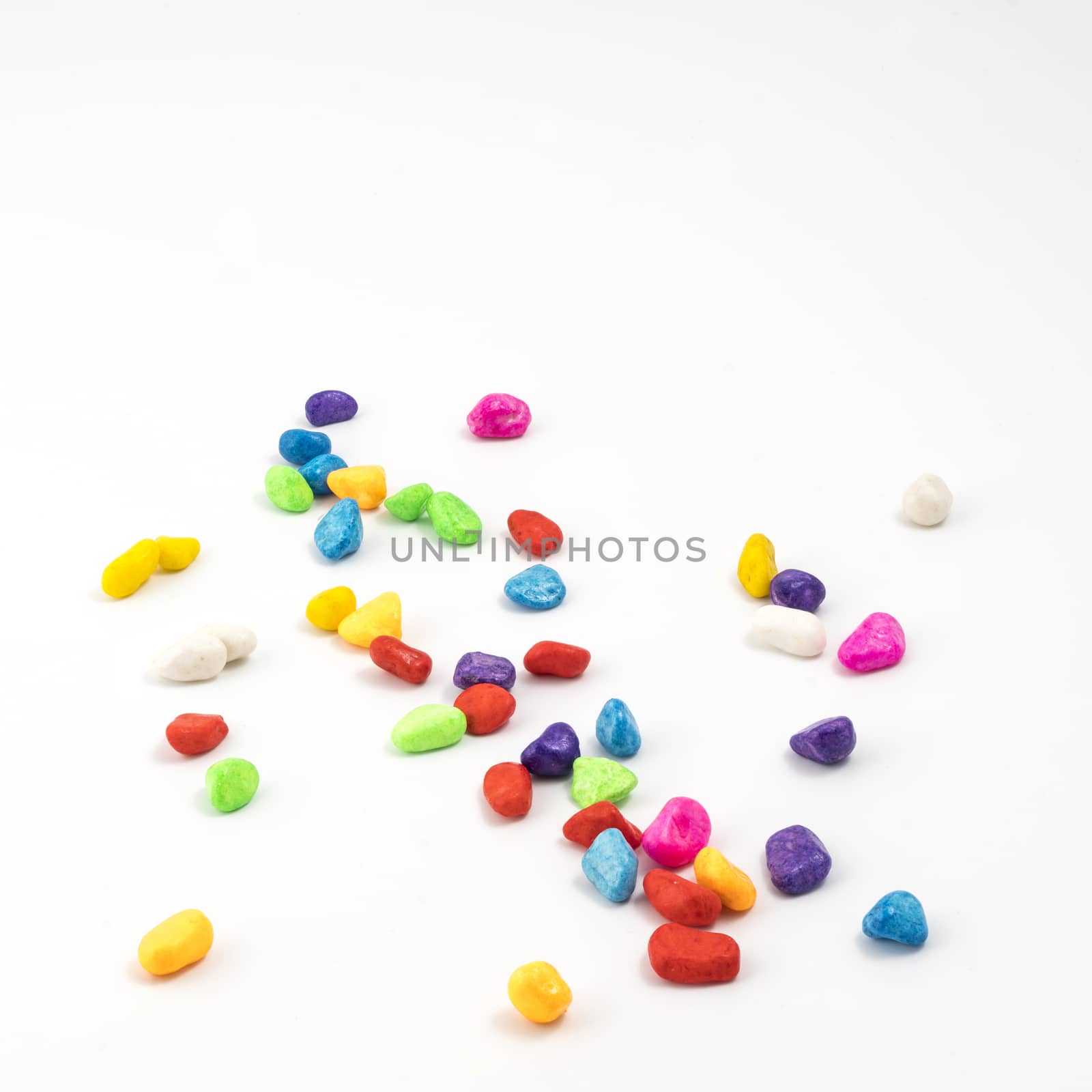 some colored pebbles on a white background