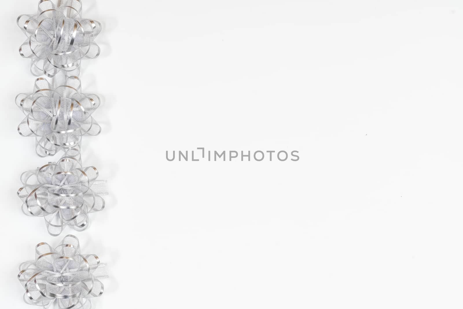 decorative silver bows on a colored background