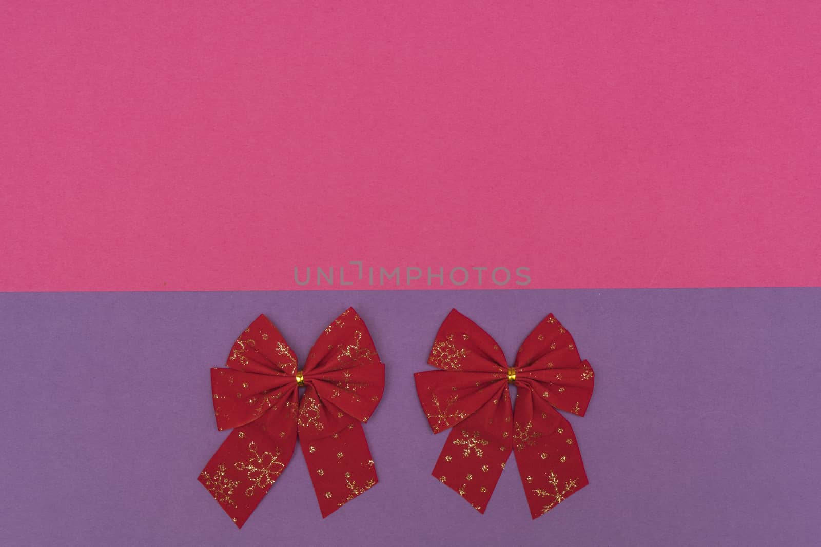 red Christmas bows on a colored background