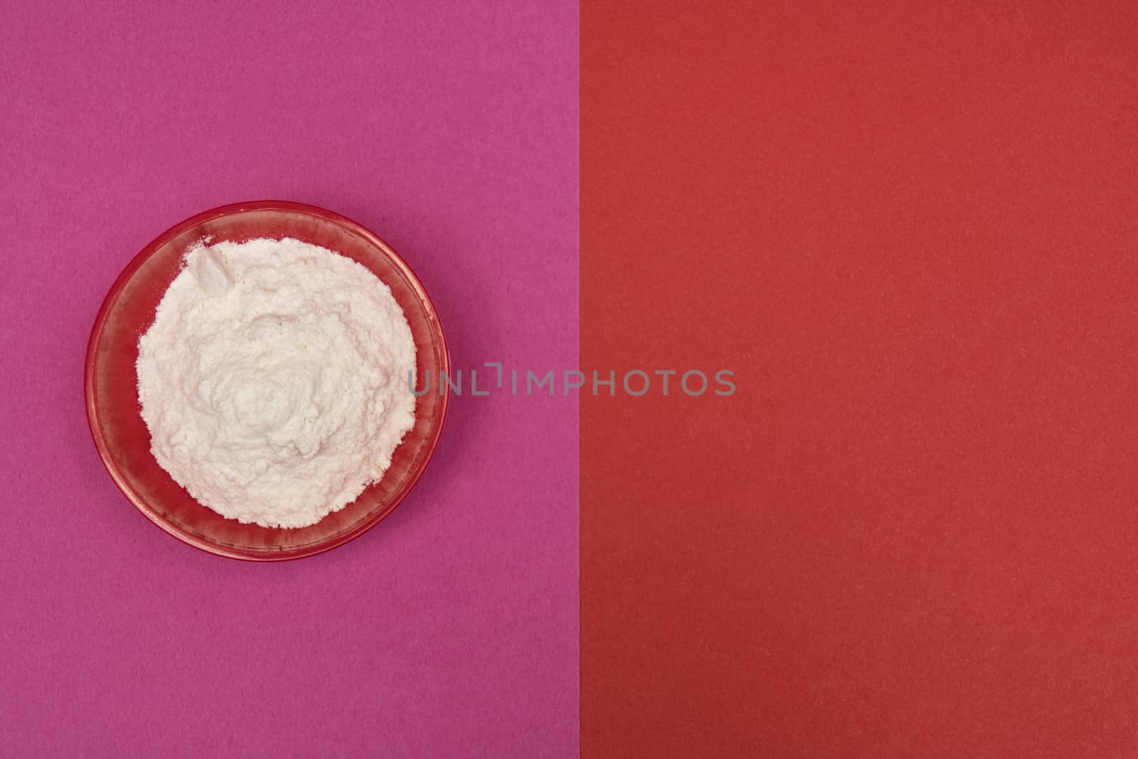 flour in a bowl on a colored background